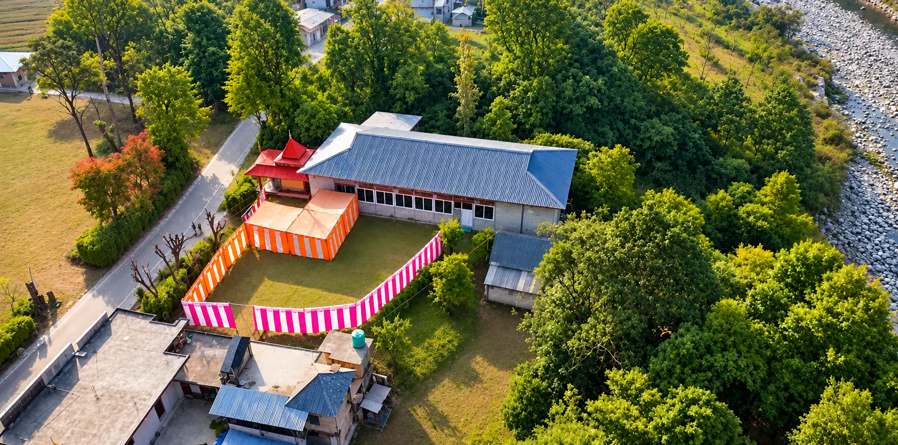 Aerial view of the Ved Banquet Hall grounds with event tent, lawn and surrounding hills